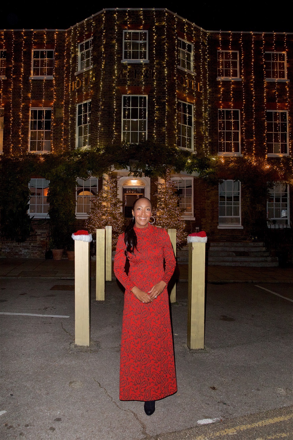 The Mitre Hotel entrance with fairy lights, Christmas trees and Santa hats on the posts